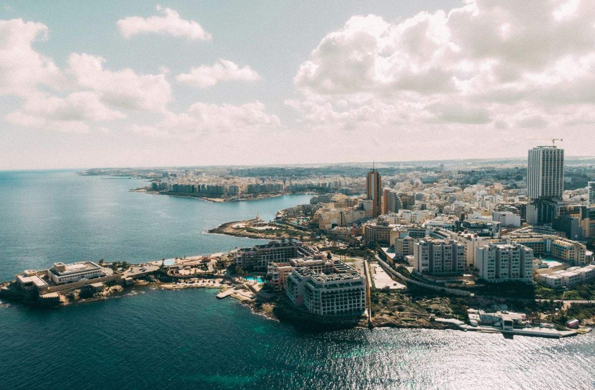an aerial view of a city and a body of water