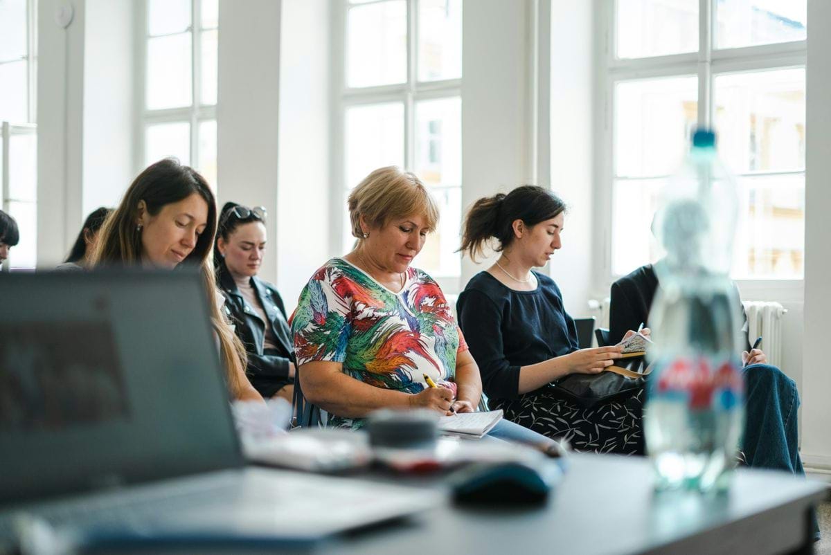 a group of women looking at a computer screen