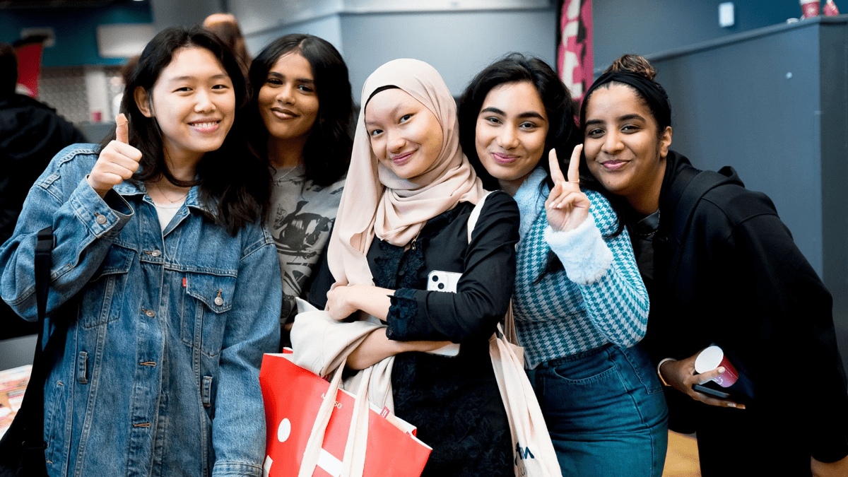 group of female students of different ethnicities posing within the students union