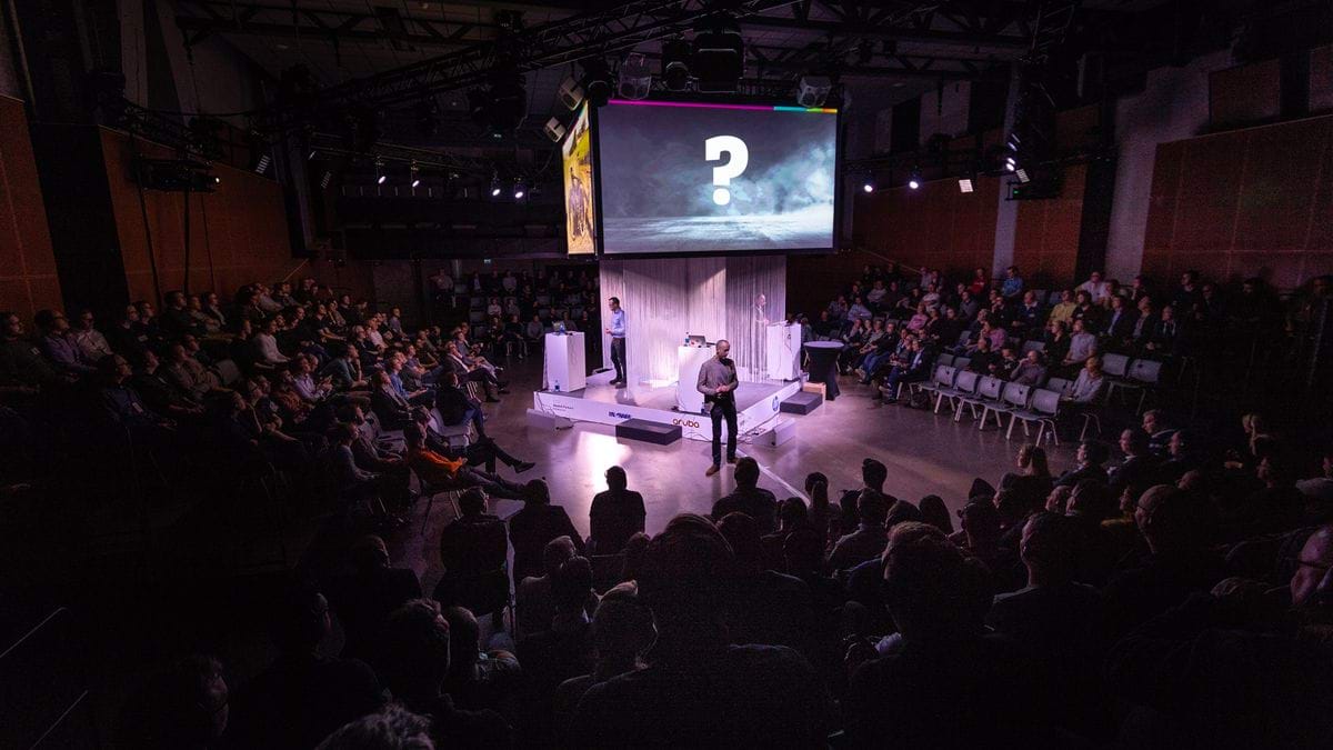 Scenpresentation med frågetecken och spotlight – föreläsning eller pitch under Advanias konferens