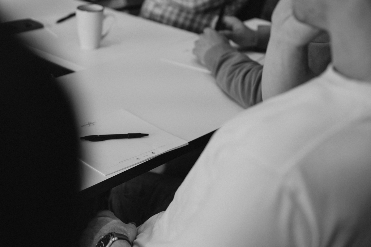 Meeting room table with hands and coffee