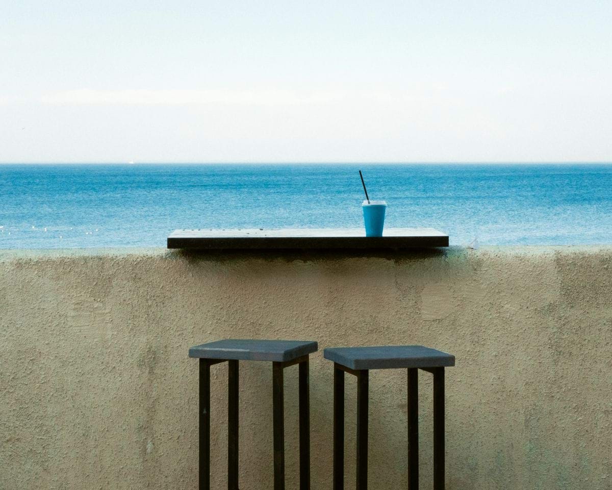 Two stools and drink by the ocean