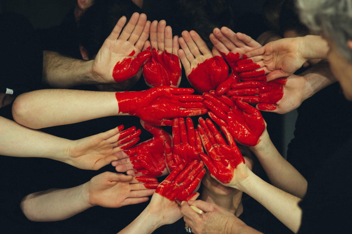 hands formed together with red heart paint.jpg