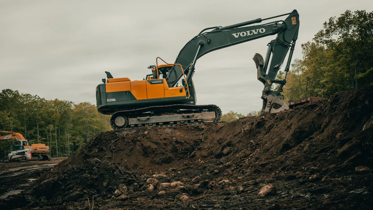 orange and white excavator on brown ground during daytime.jpg