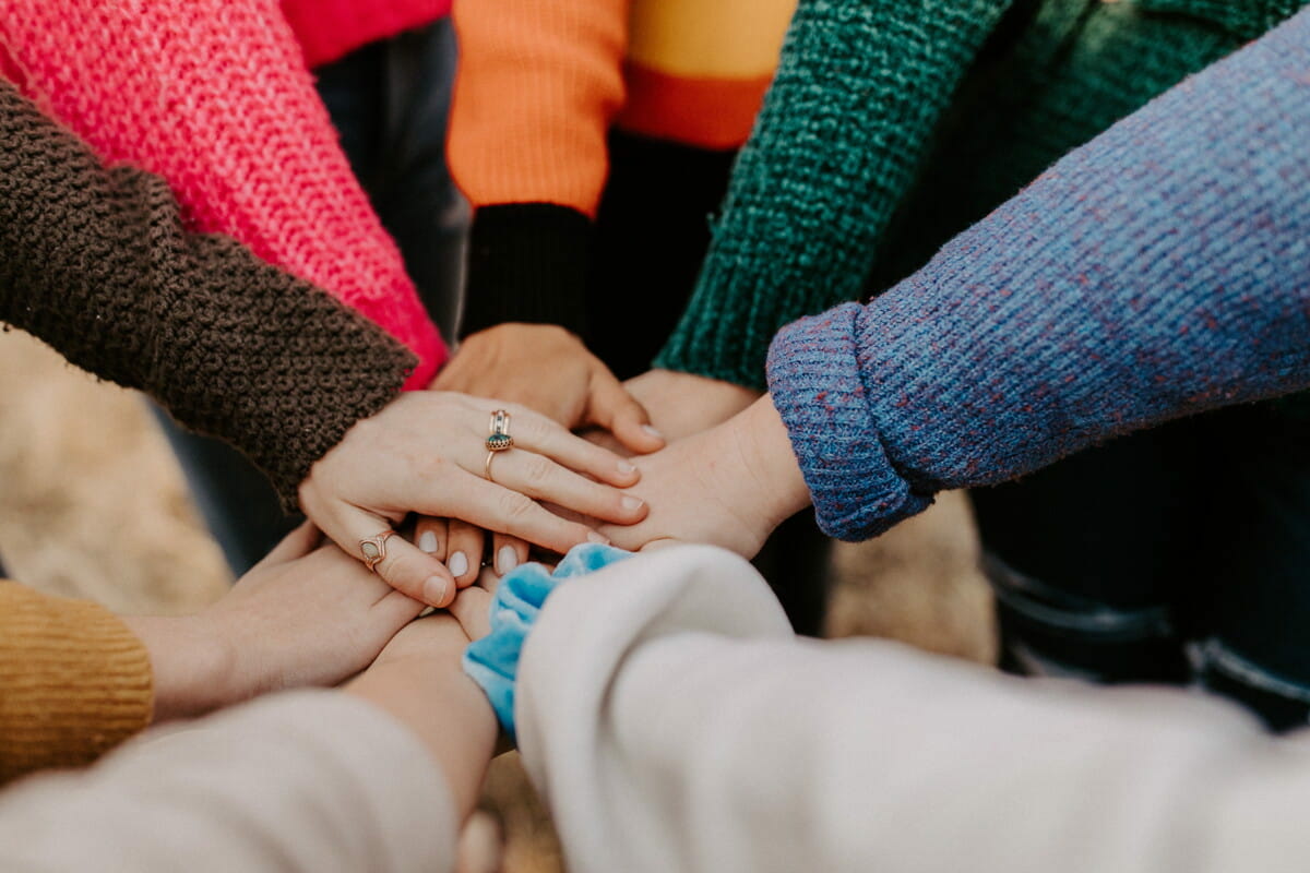 person in red sweater holding babys hand.jpg