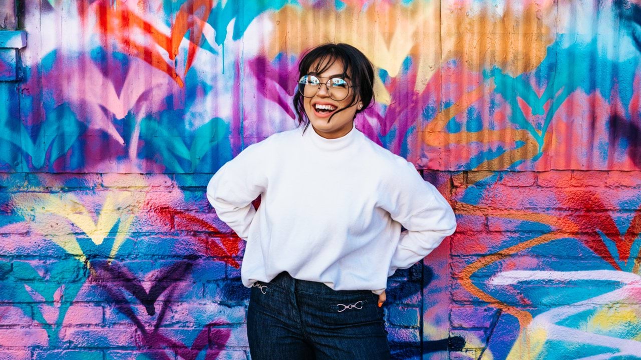 woman standing in front of multicolored wall