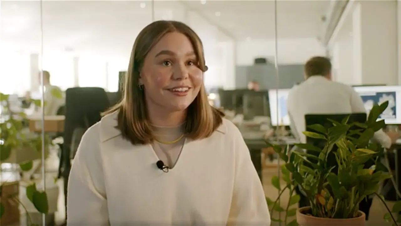 female employee at an office explaining her work