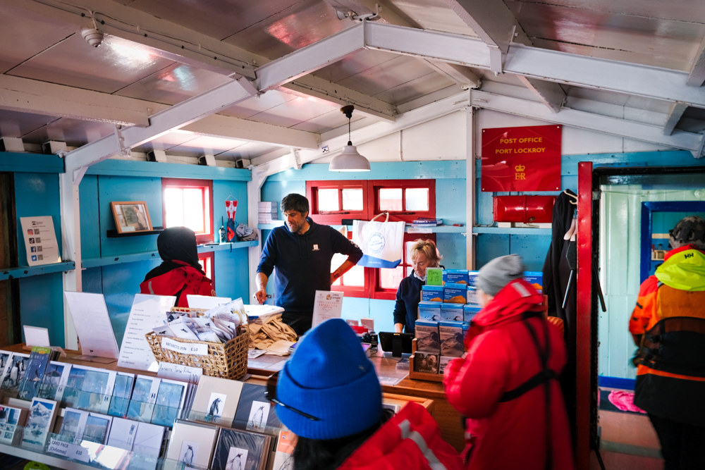 visitors inside Port Lockroy shop