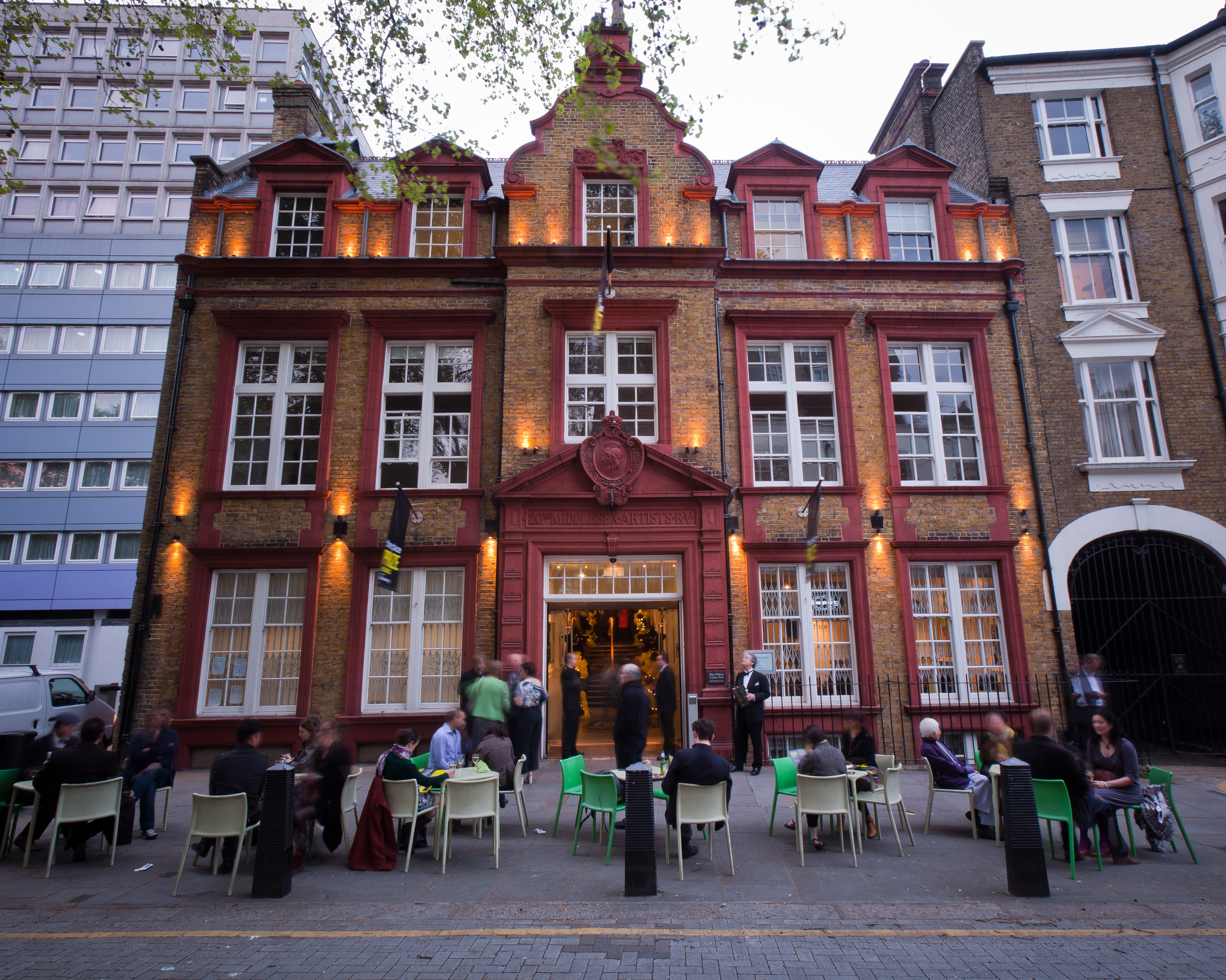 The Place entrance with a few people sitting around tables