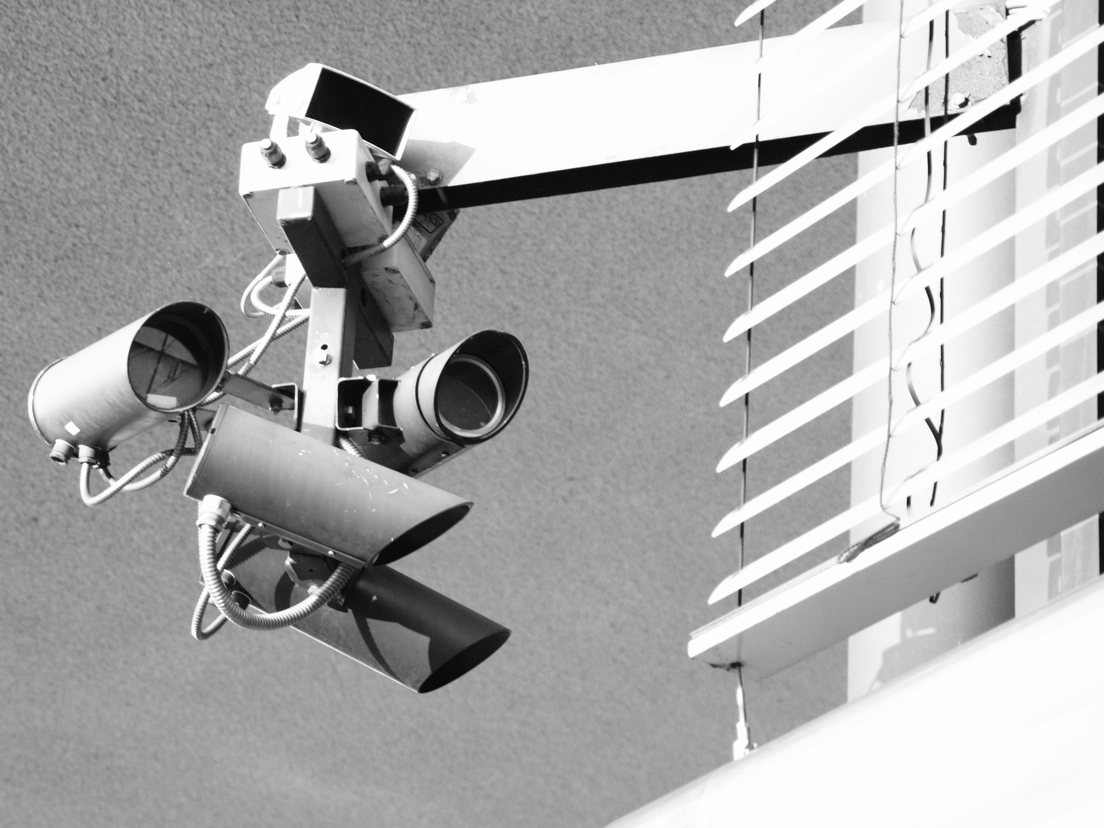 Surveillance cameras mounted on a building exterior.