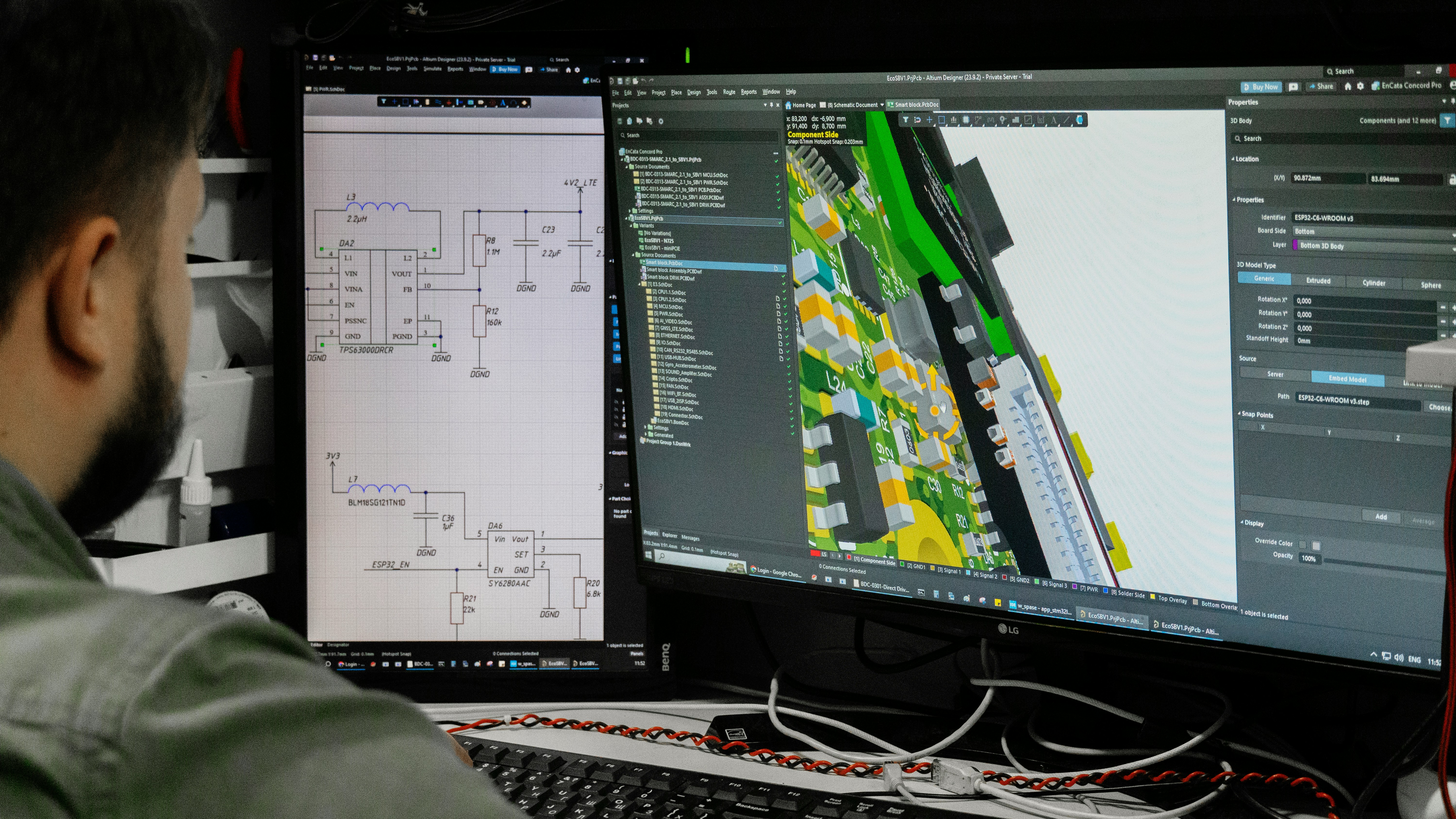 Man looking at circuit board design on computer screen.