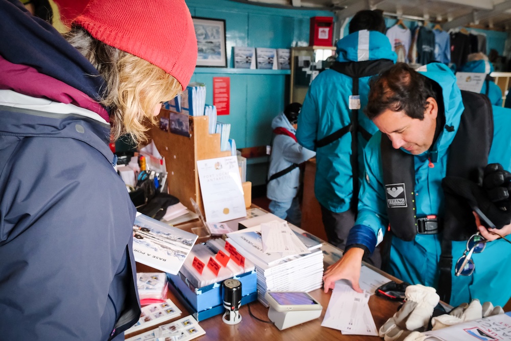 A staff member serves customers at Port Lockroy
