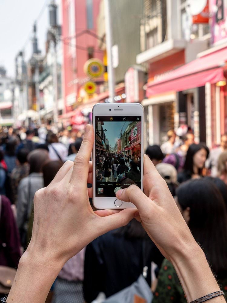 person taking a photo of people