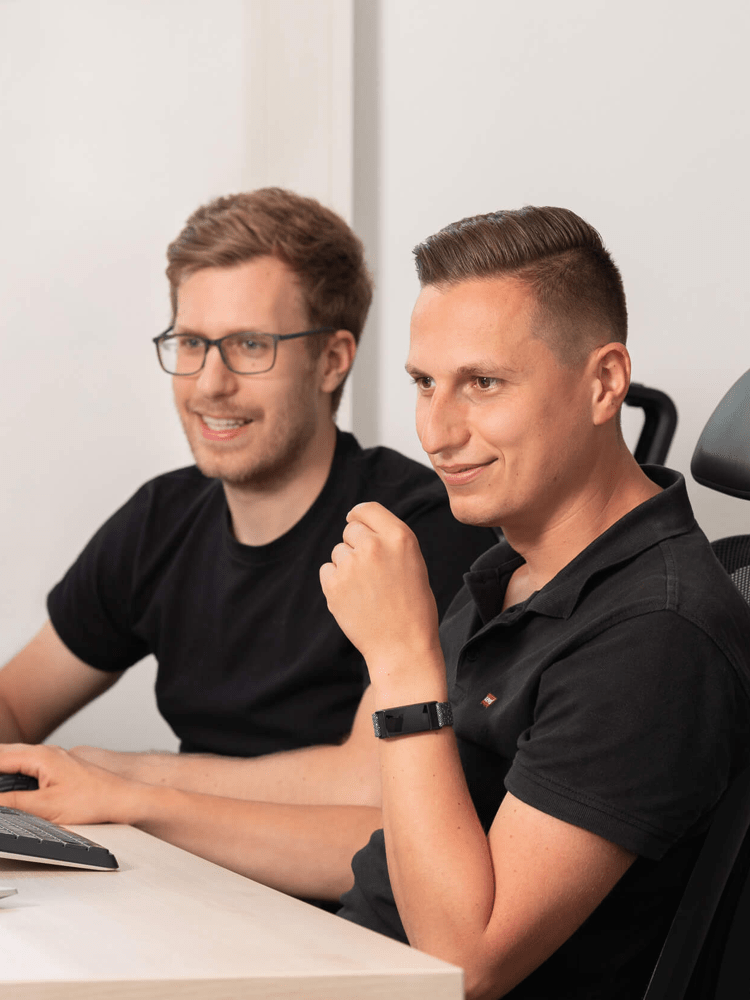 Zwei SAP-Entwickler besprechen eine prismat-Lösung gemeinsam am Bildschirm