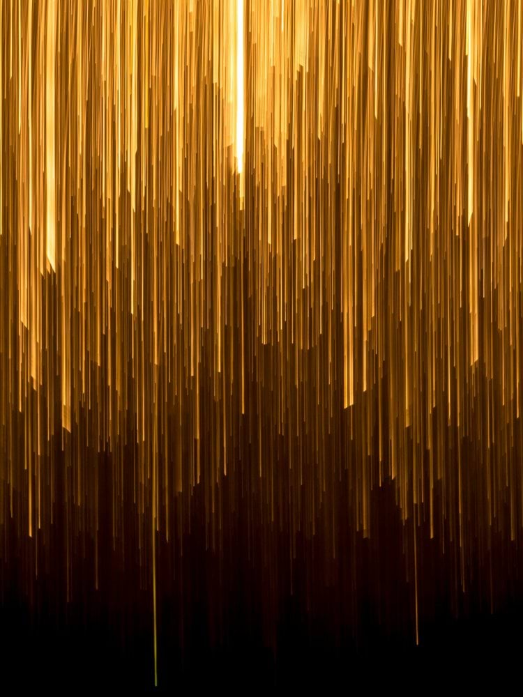 a very long line of yellow lines on a black background