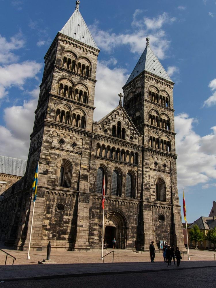 A tall church stands prominently under a sunny sky