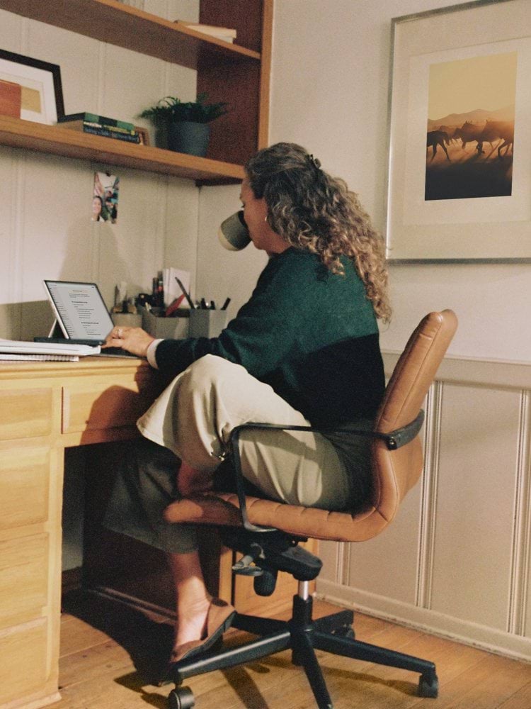 Woman working at desk with coffee
