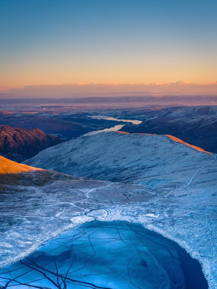 a view of a lake in the middle of a mountain range