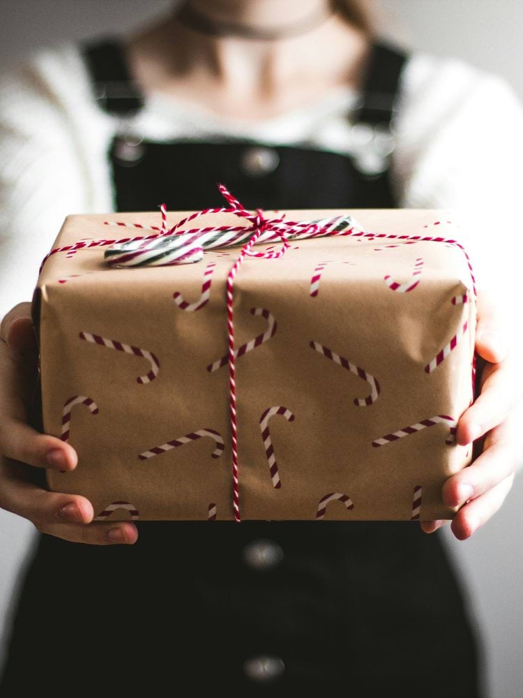person showing brown gift box