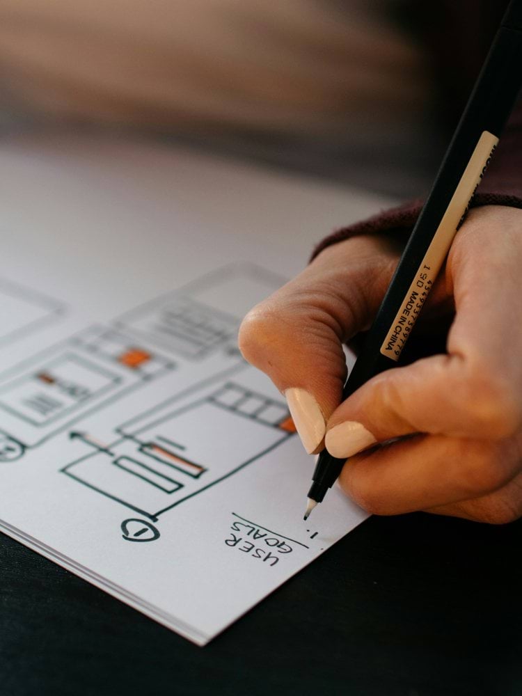 person writing on white paper