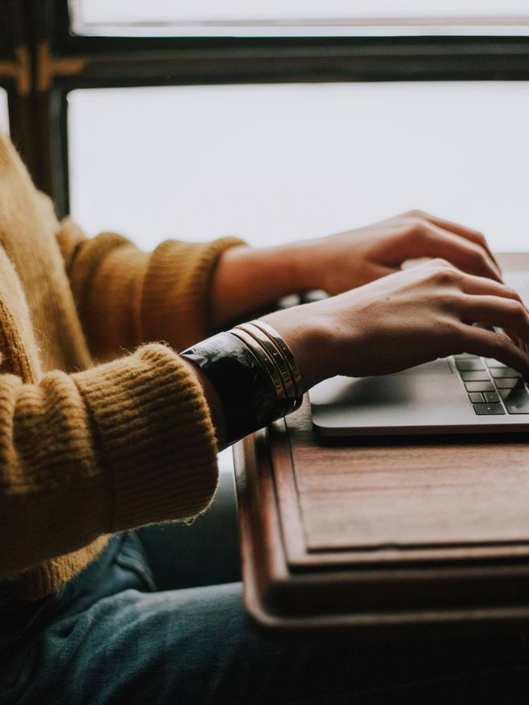 person sitting front of laptop