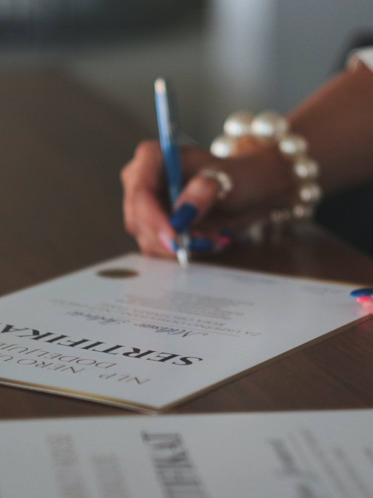 a woman writing on a piece of paper