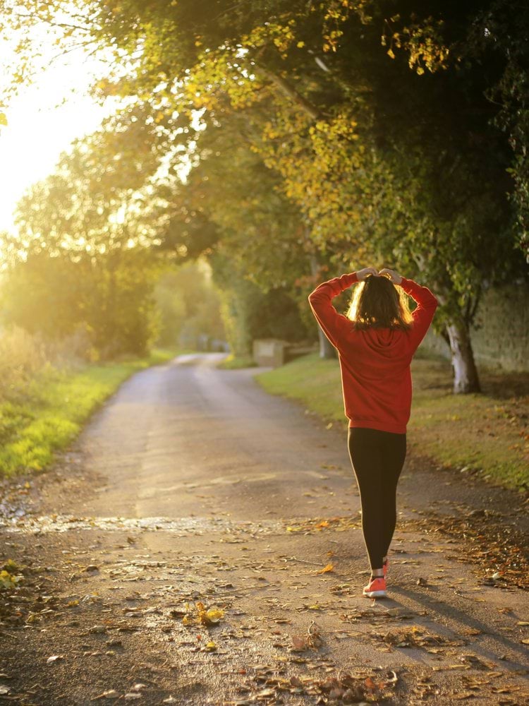 woman walking on pathway during daytime