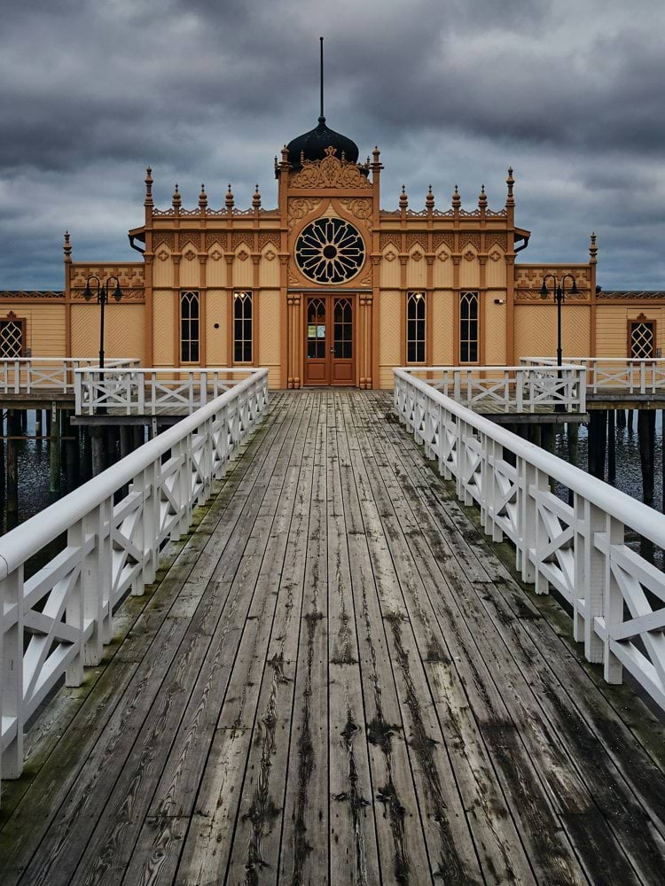 wooden pier in front of beige building