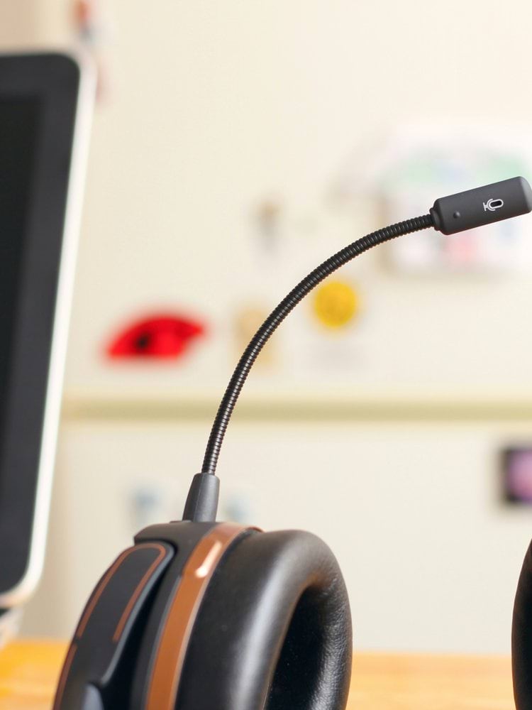 black and brown headset near laptop computer