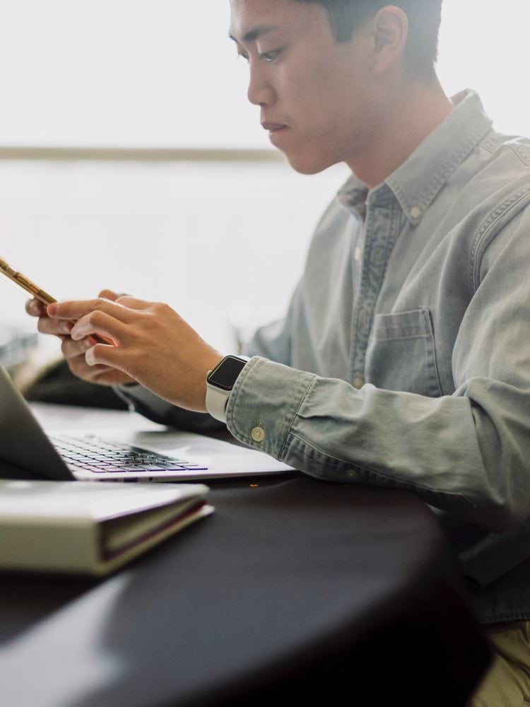 a man sitting in front of a laptop computer