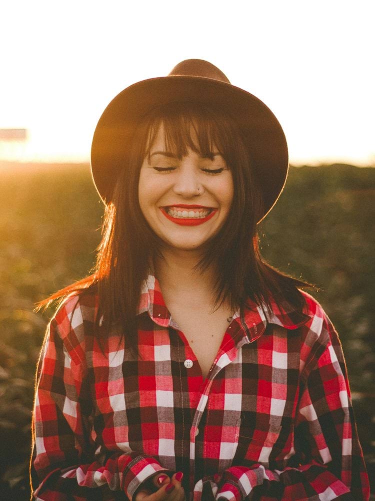 golden hour photography of woman in red and white checkered dress shirt