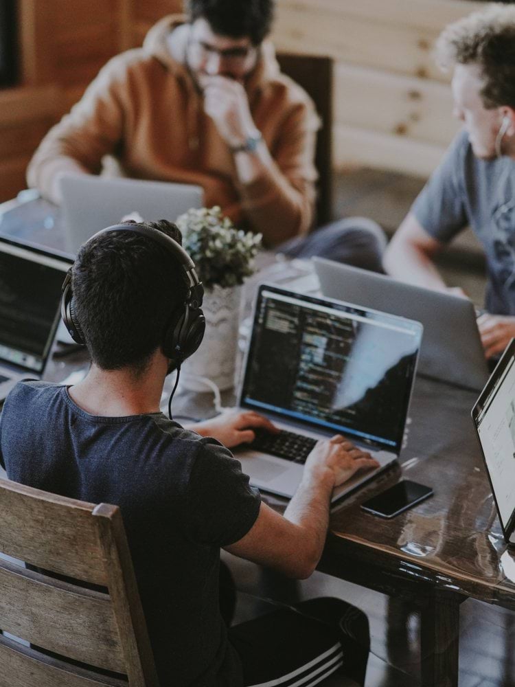 group of people using laptop computer