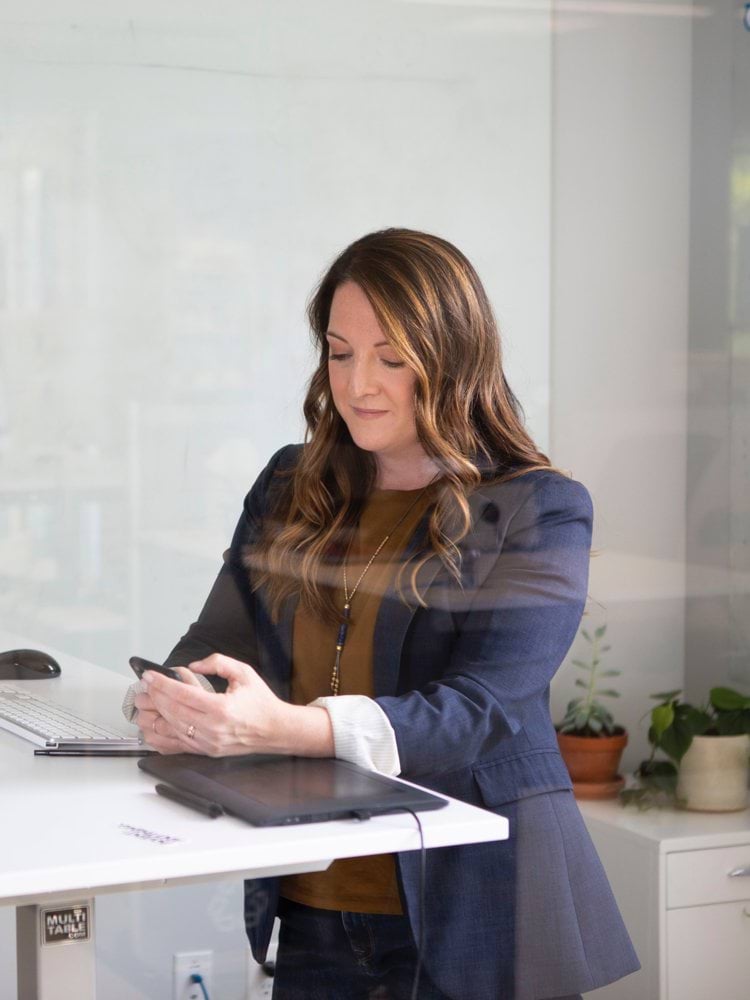 woman in black leather jacket using macbook air