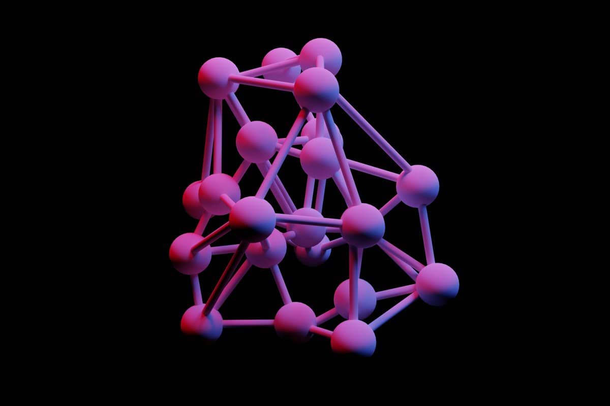 a group of pink and blue balls on a black background