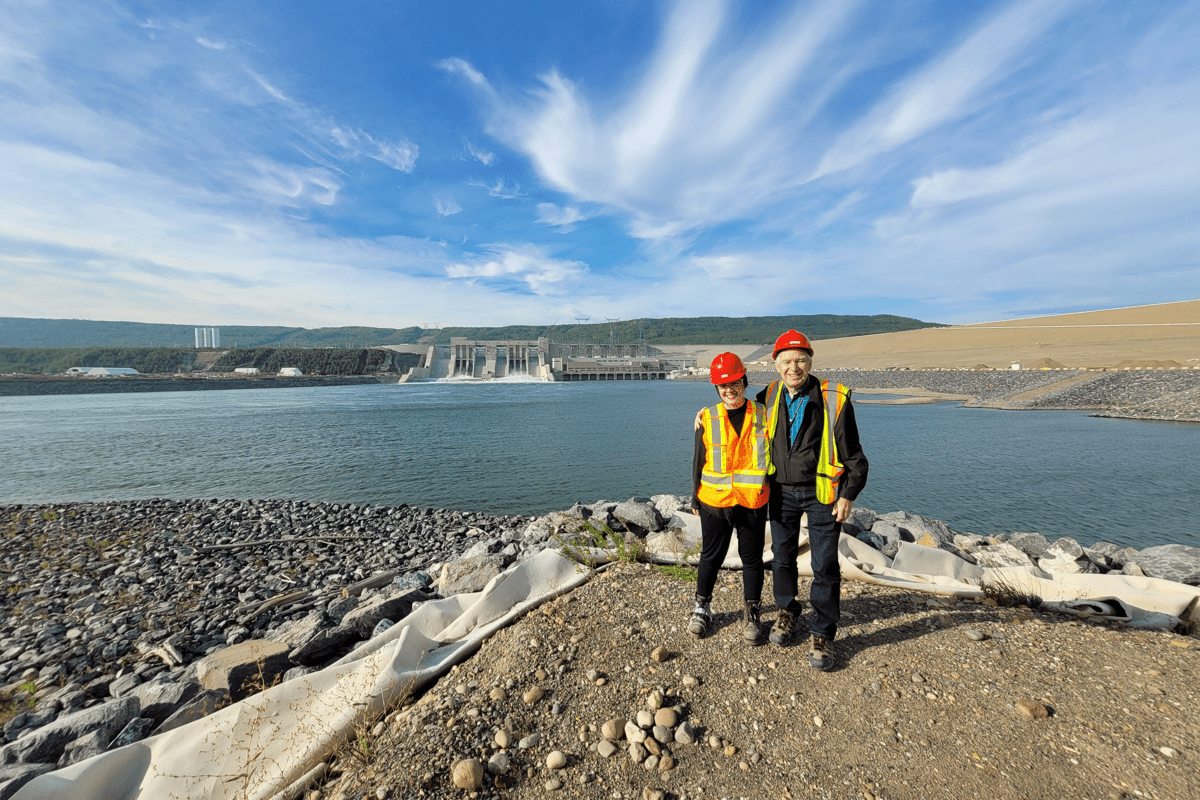 Two coworkers standing in front of a Power and Transportation project
