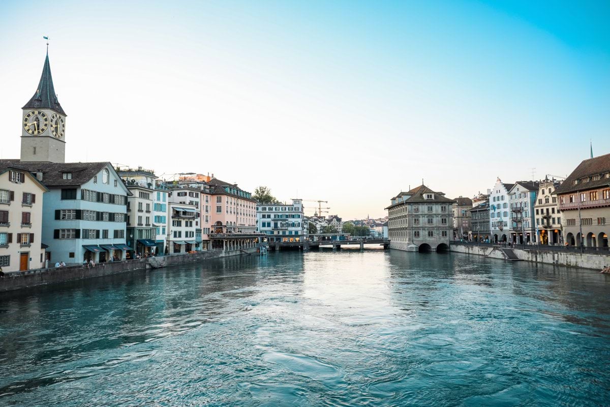 body of water between buildings under blue sky during daytime