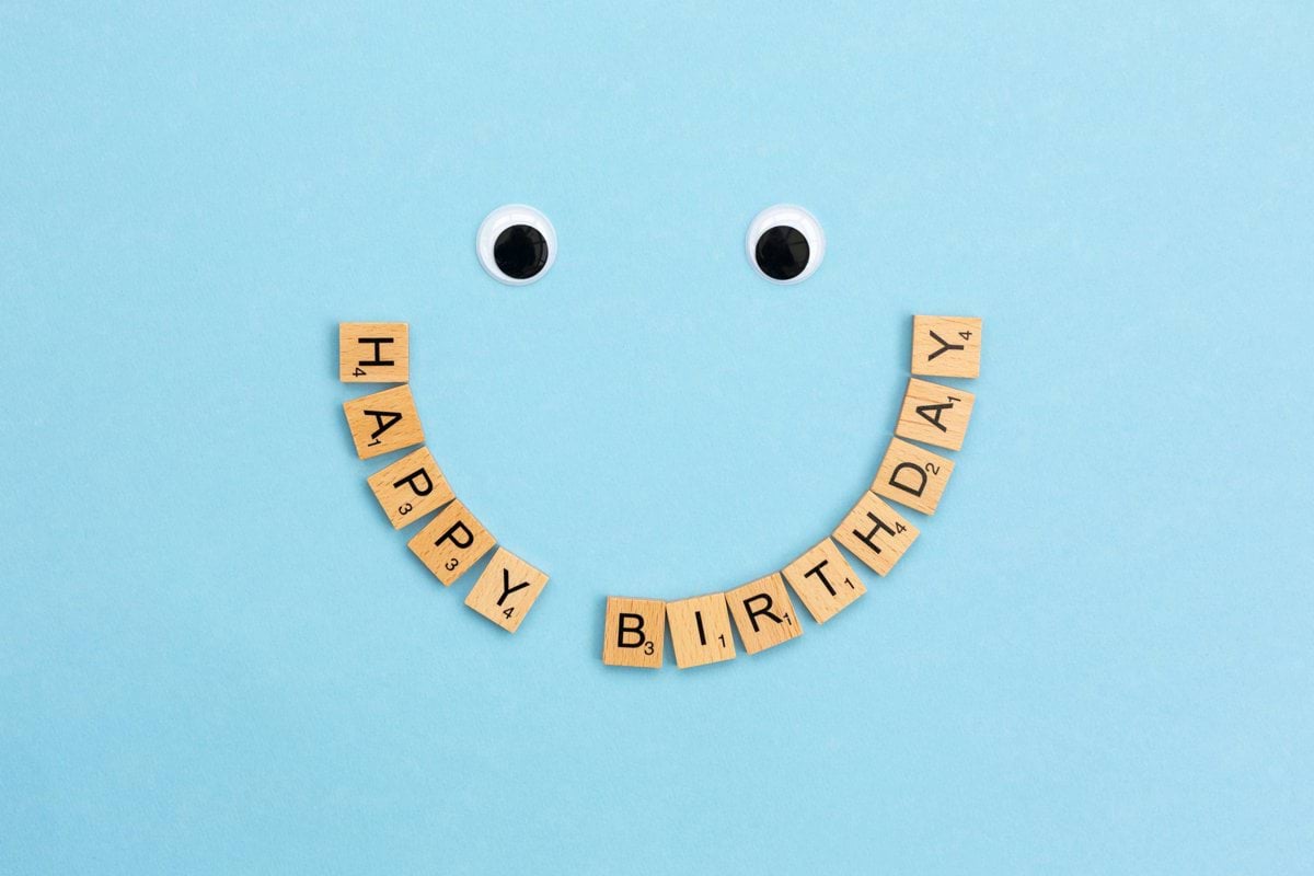 a smiley face made out of scrabbles with the words happy birthday spelled