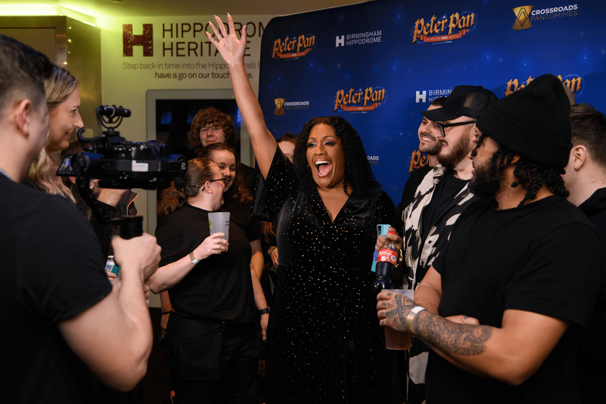 Behind the scenes photo of Alison Hammond and team members during a press day at the venue.