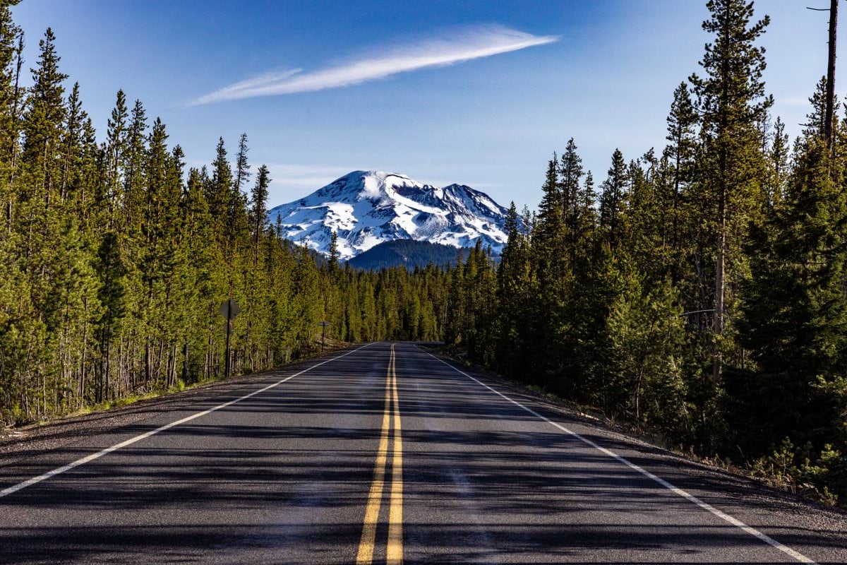 a road with a mountain in the background