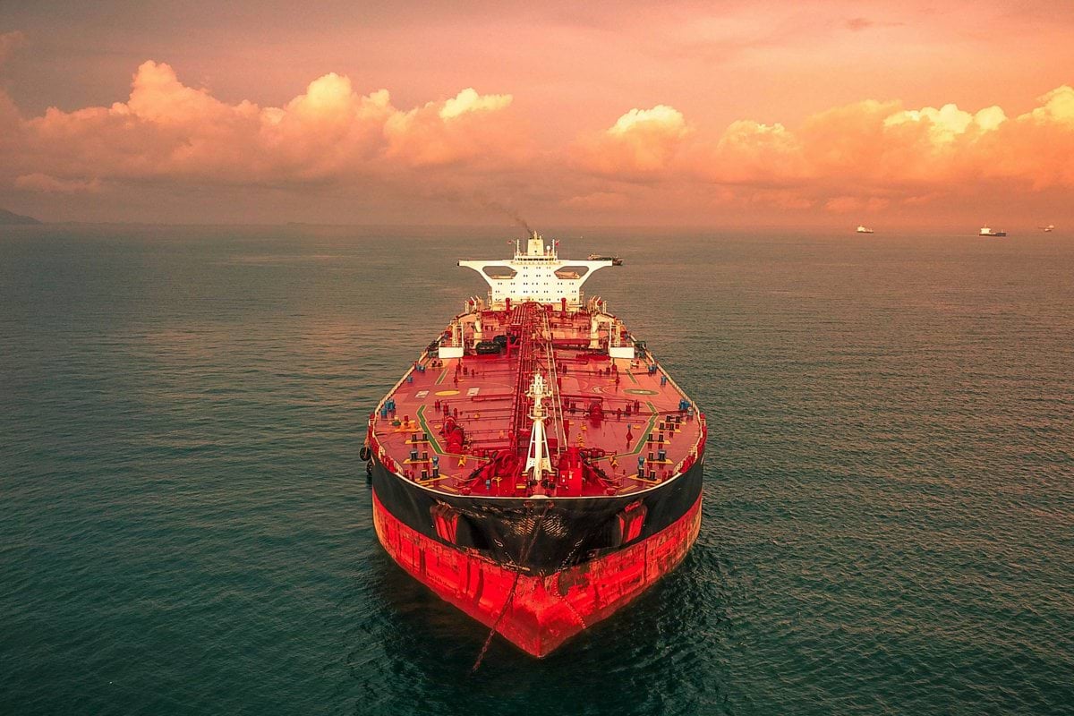 red and white ship on sea under cloudy sky during daytime