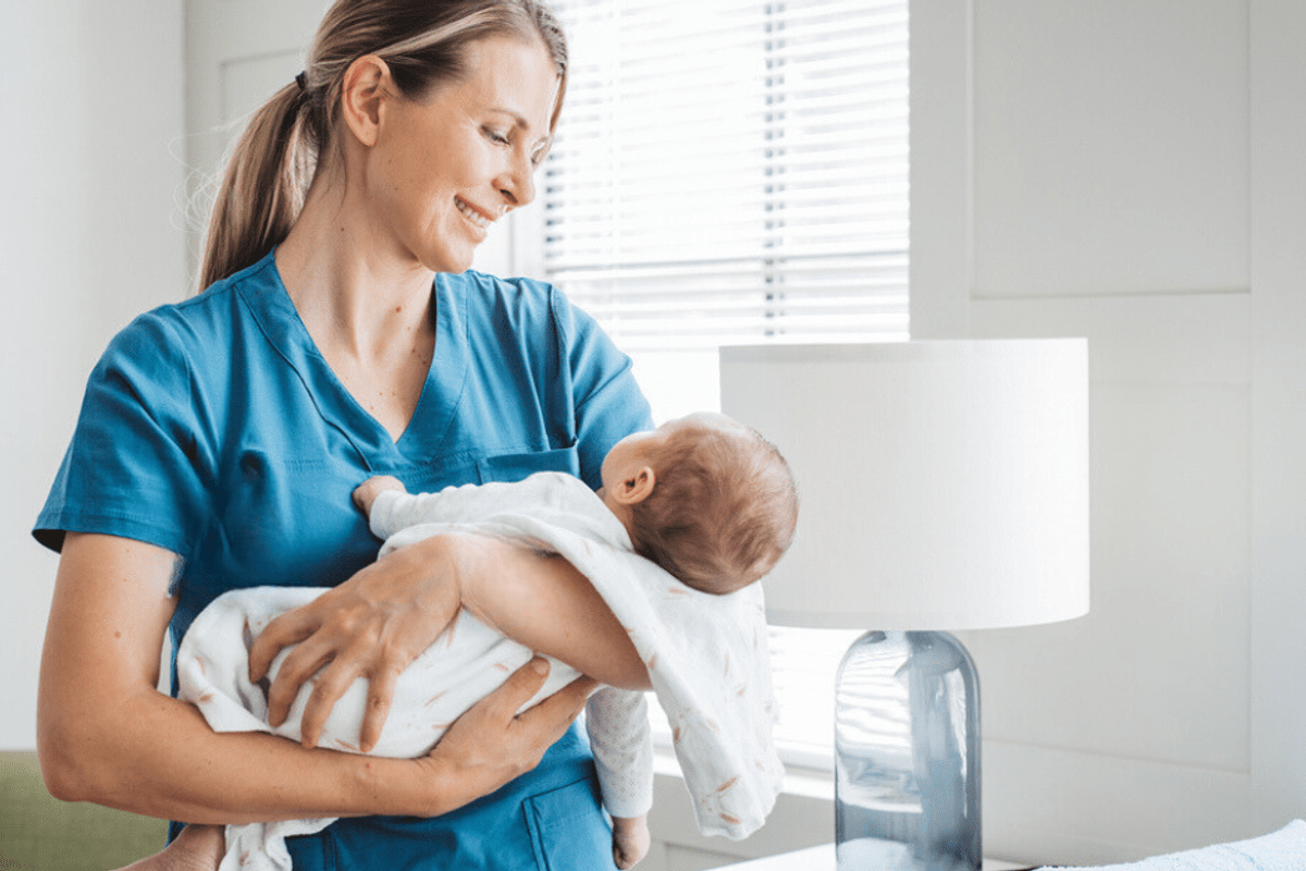 Midwife Holding Baby in Hospital