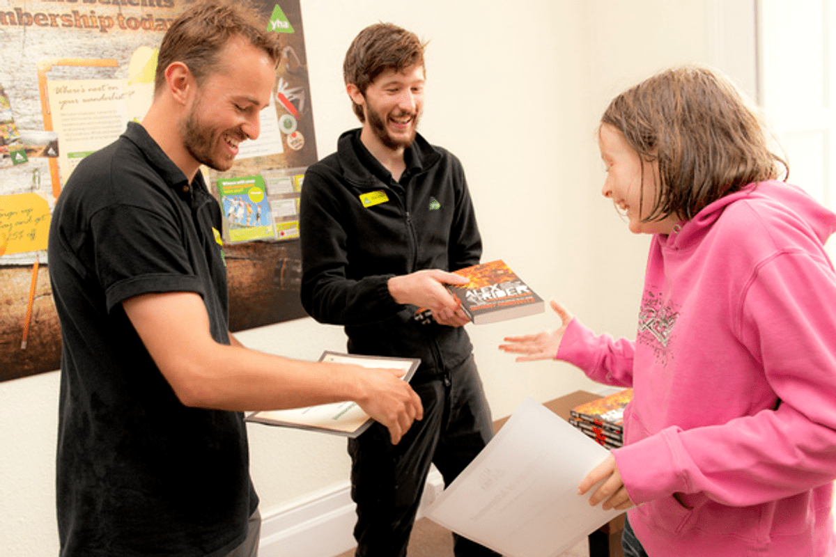 Staff handing out Alex Rider books