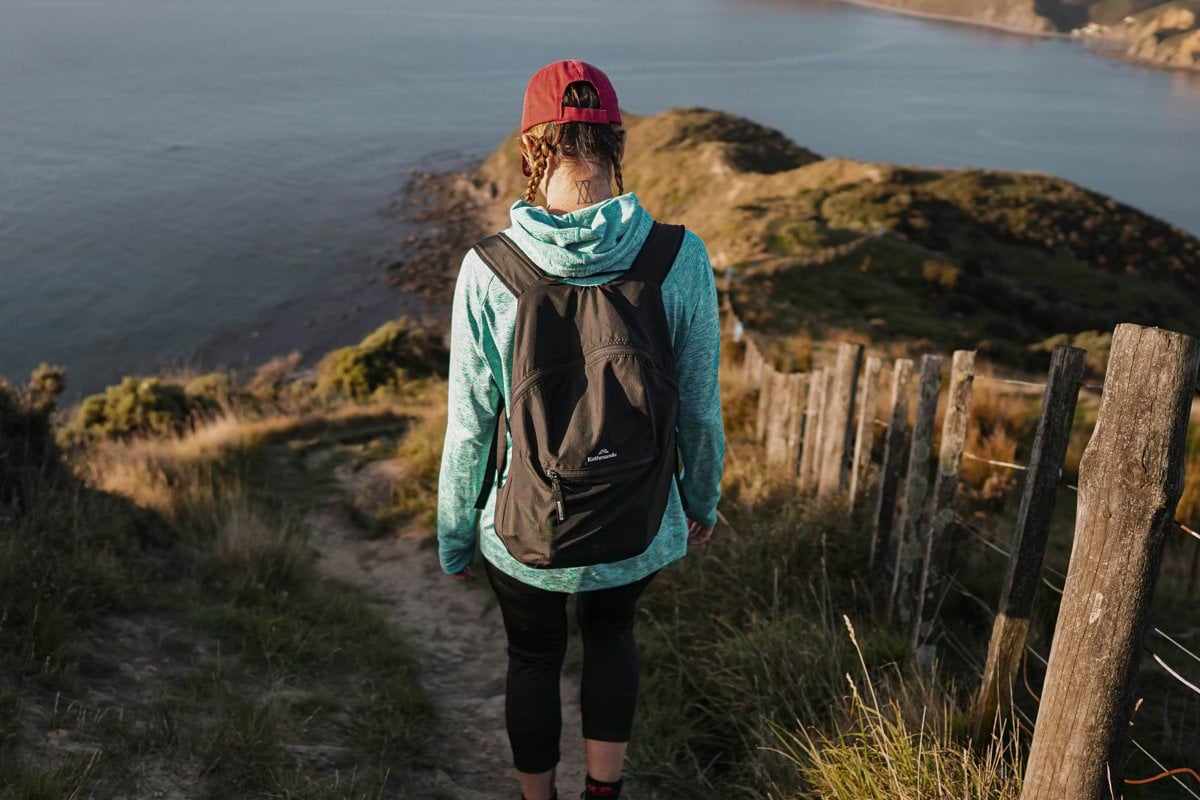 a person with a backpack walking up a hill