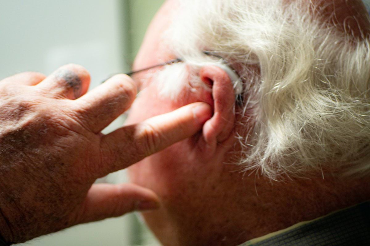 a man with his hand on his face