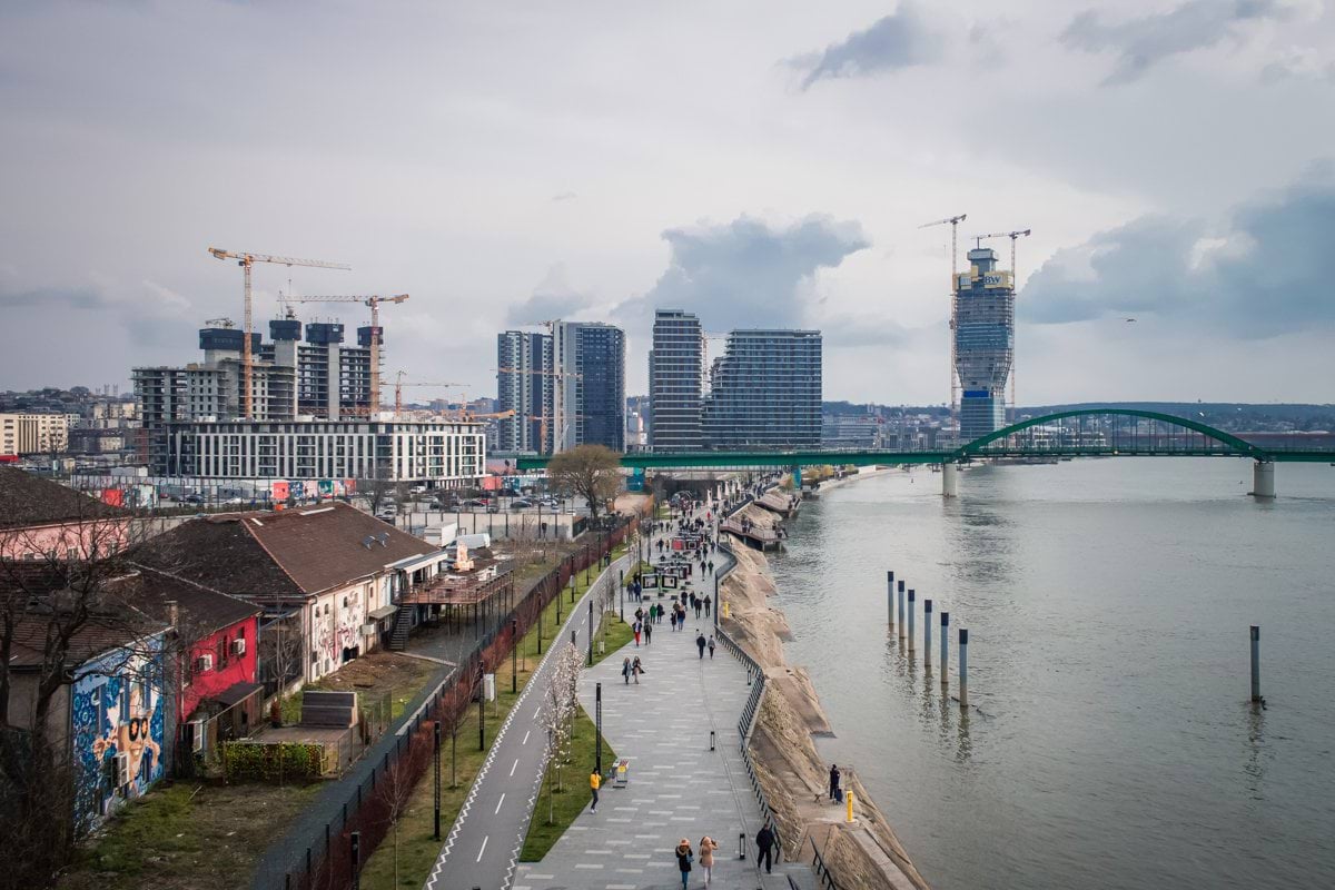 people walking on dock near body of water during daytime