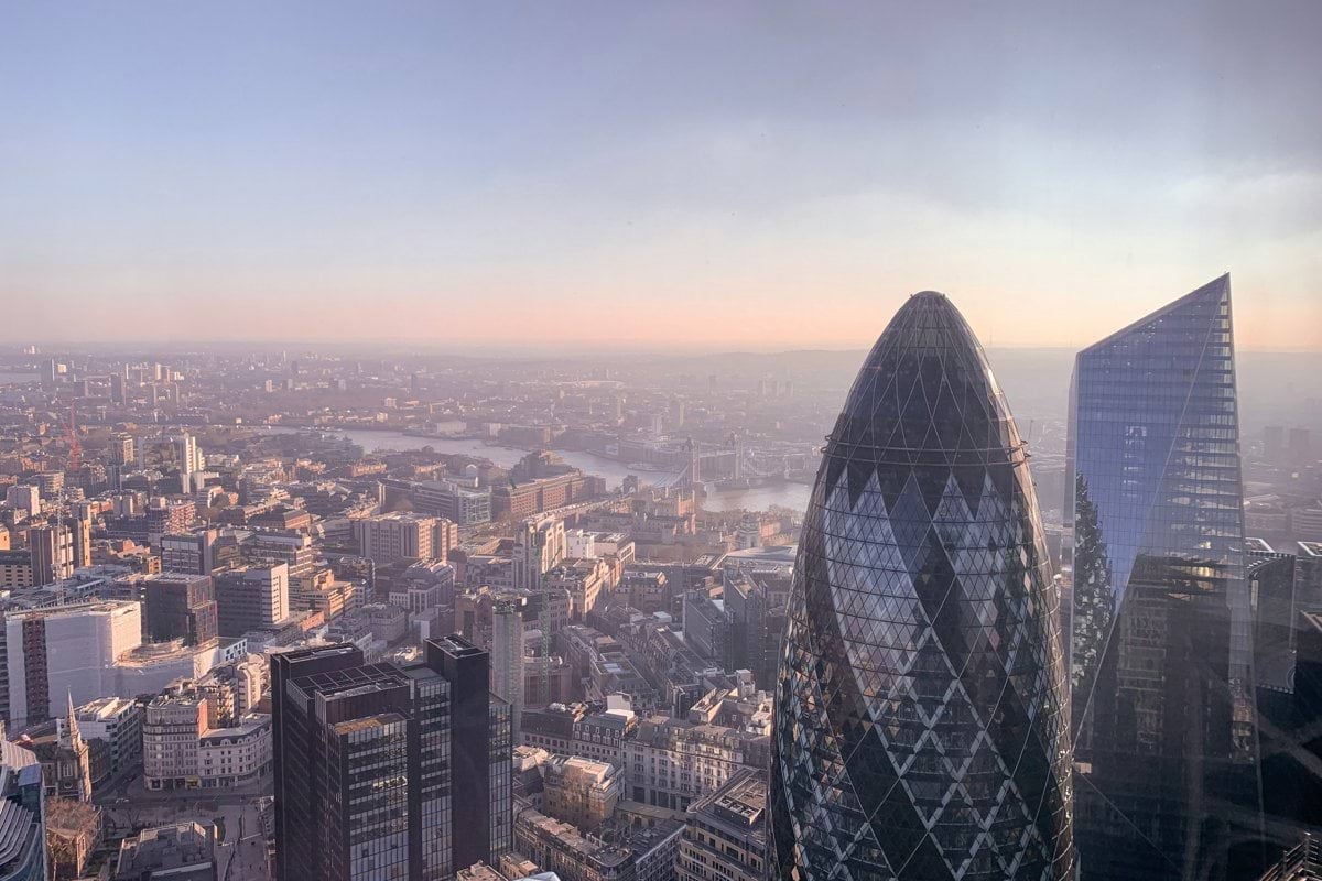 The London skyline with the Gherkin building and the Thames River at low sun