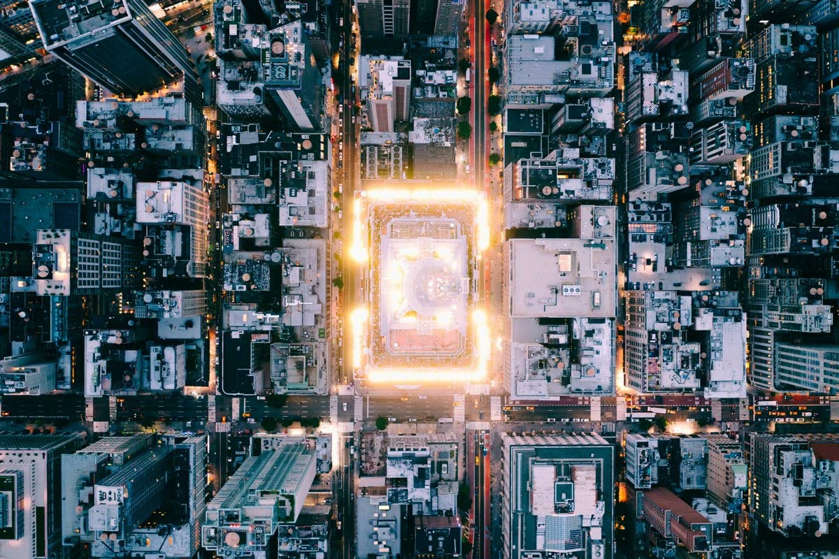 Aerial view of a brightly lit city at dusk.