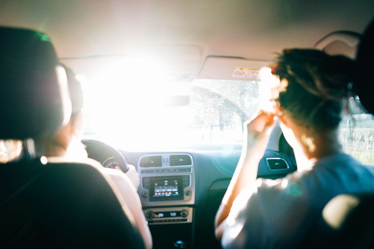 Exploring with friends during roadtrip in summer in car