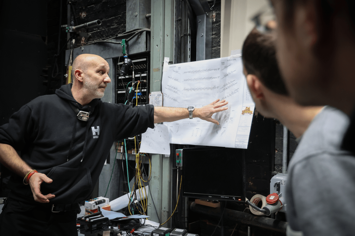 Technical team member highlighting interesting features of the theatre to the public during Backstage tour.