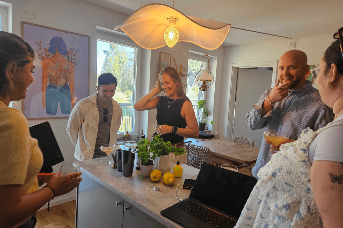 A group of people in a kitchen talking